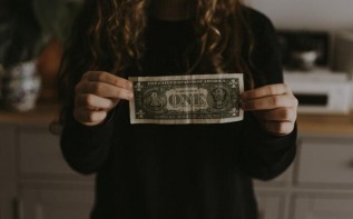 Woman holding a dollar bill
