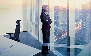 corporate woman looking outside of office window